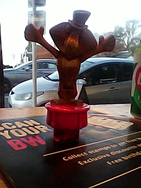 grainy photo of a worn plastic toy of Alex the Lion. It looks disgusting.