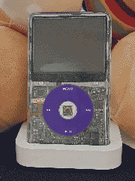 An IPod mp3 player, whith a transparent front, revealing it's circuitboard beneath. It's buttons are purple